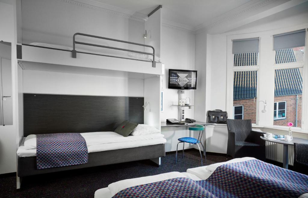A compact plain room with a fitted bed and a small washing cabin.